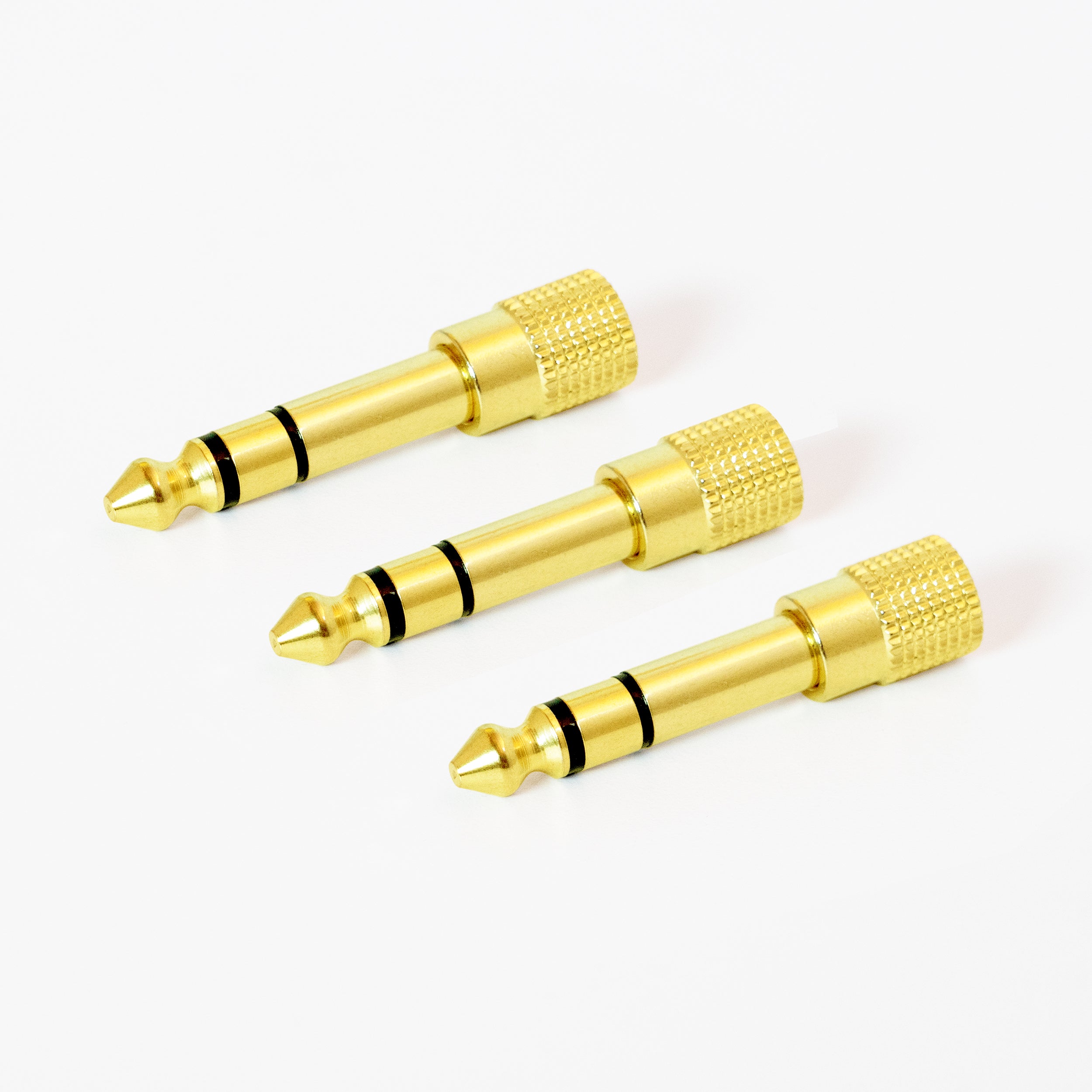 3 gold-plated 1/4 inch stereo audio adapter with a knurled grip.