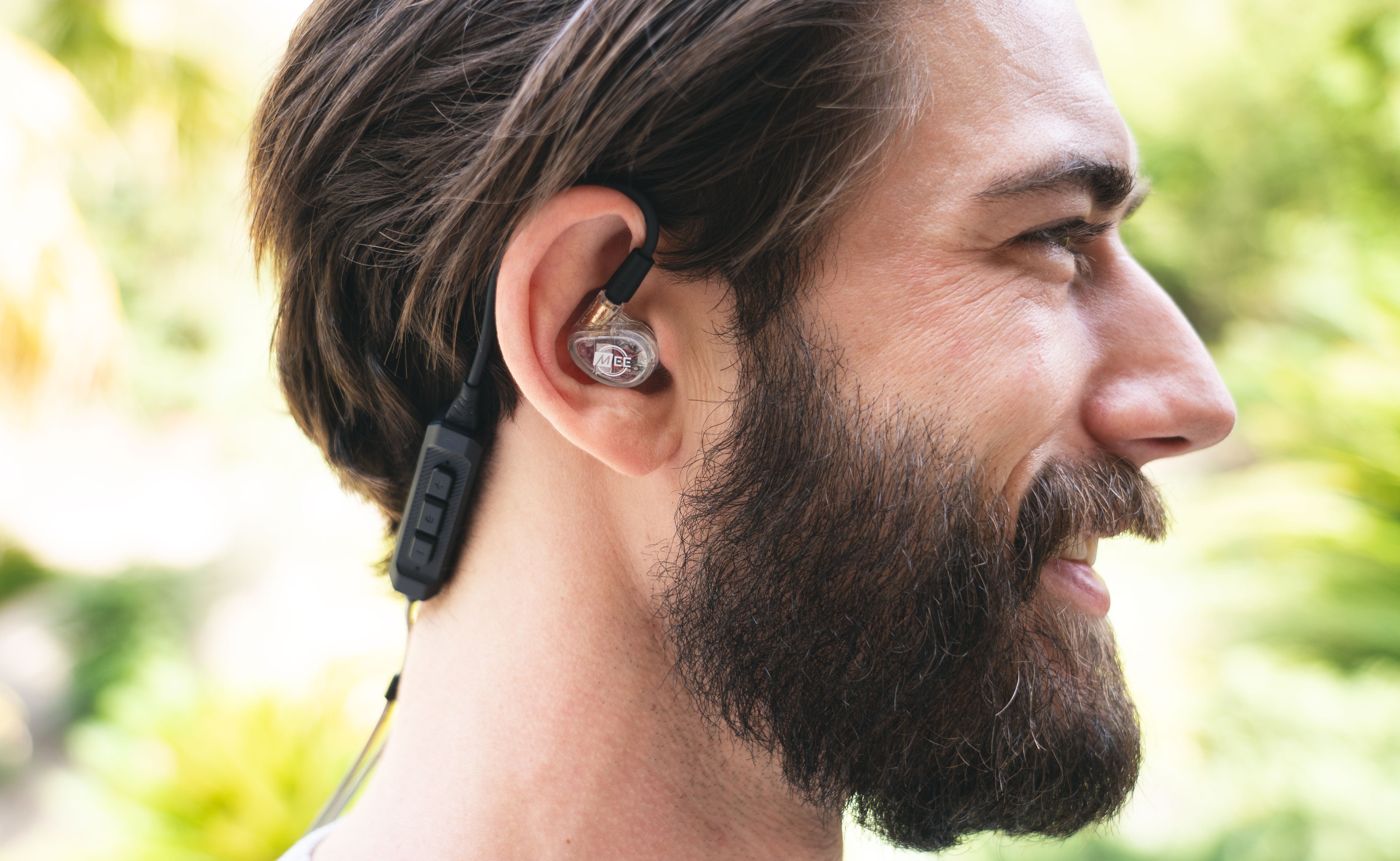 Man wearing BT3 Bluetooth Wireless Adapter Cable for In-Ear Monitors