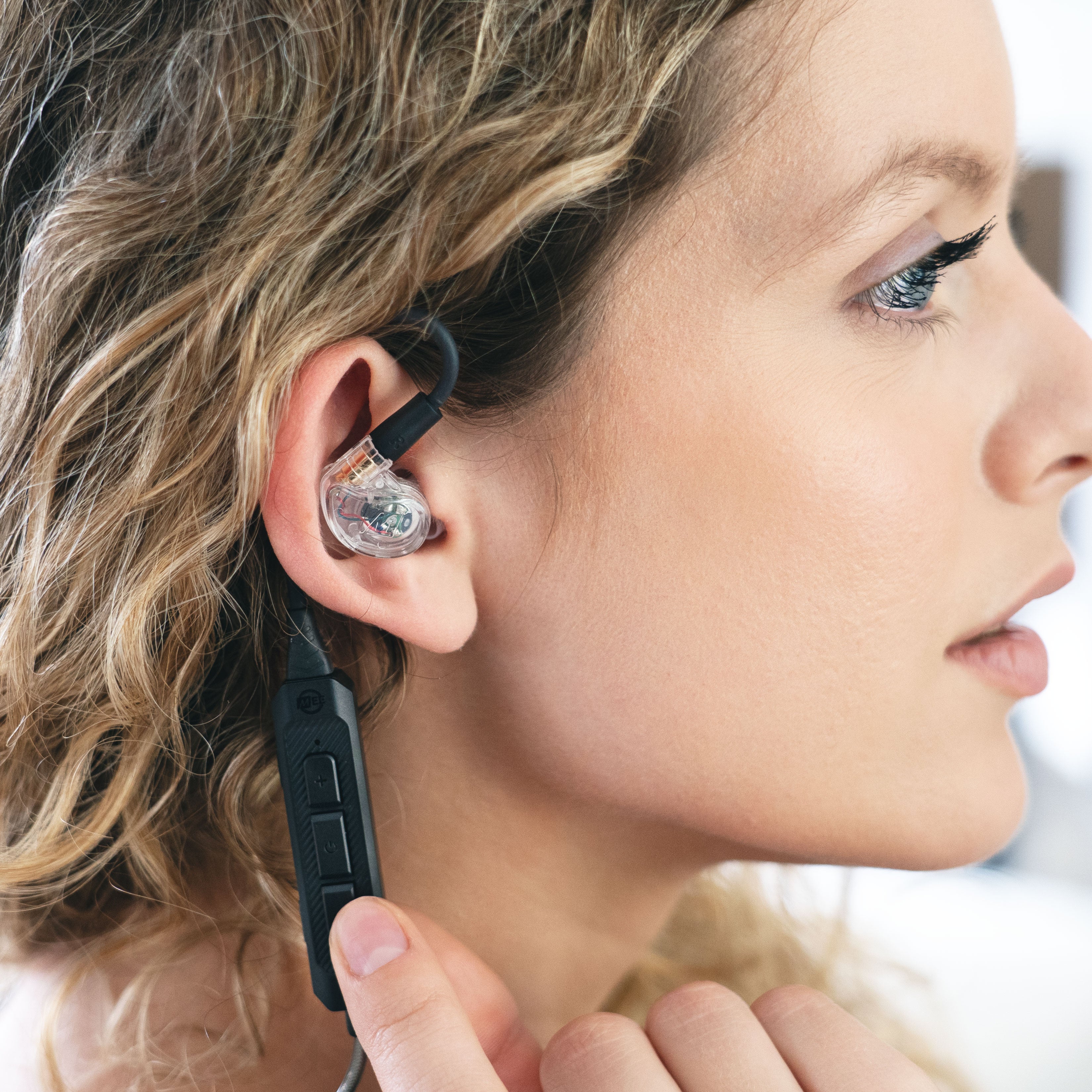 Woman wearing BT3 Bluetooth Wireless Adapter Cable for In-Ear Monitors