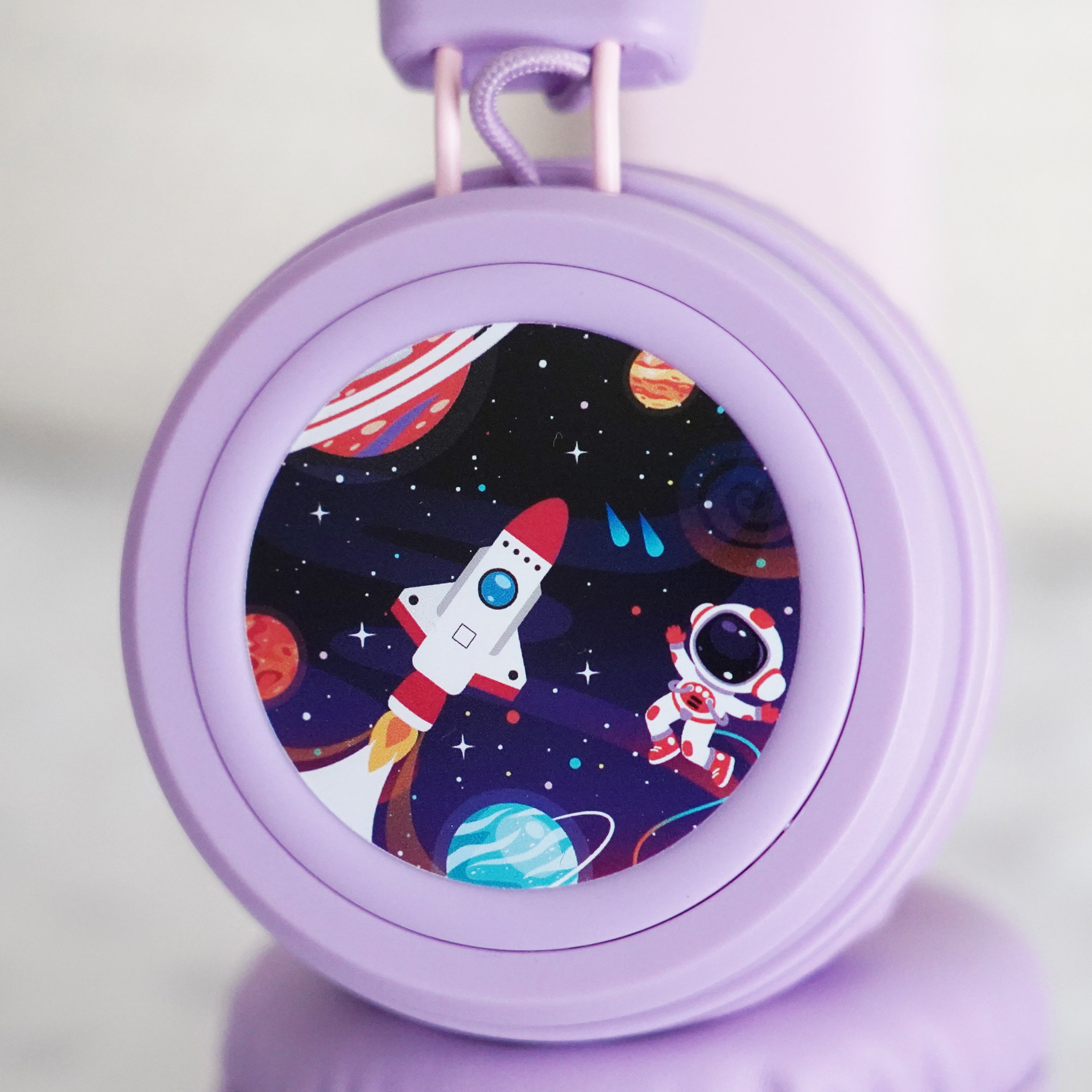 Lavender KidJamz KJ55AUX headphones faceplate with an outer space design in color on a light gray background