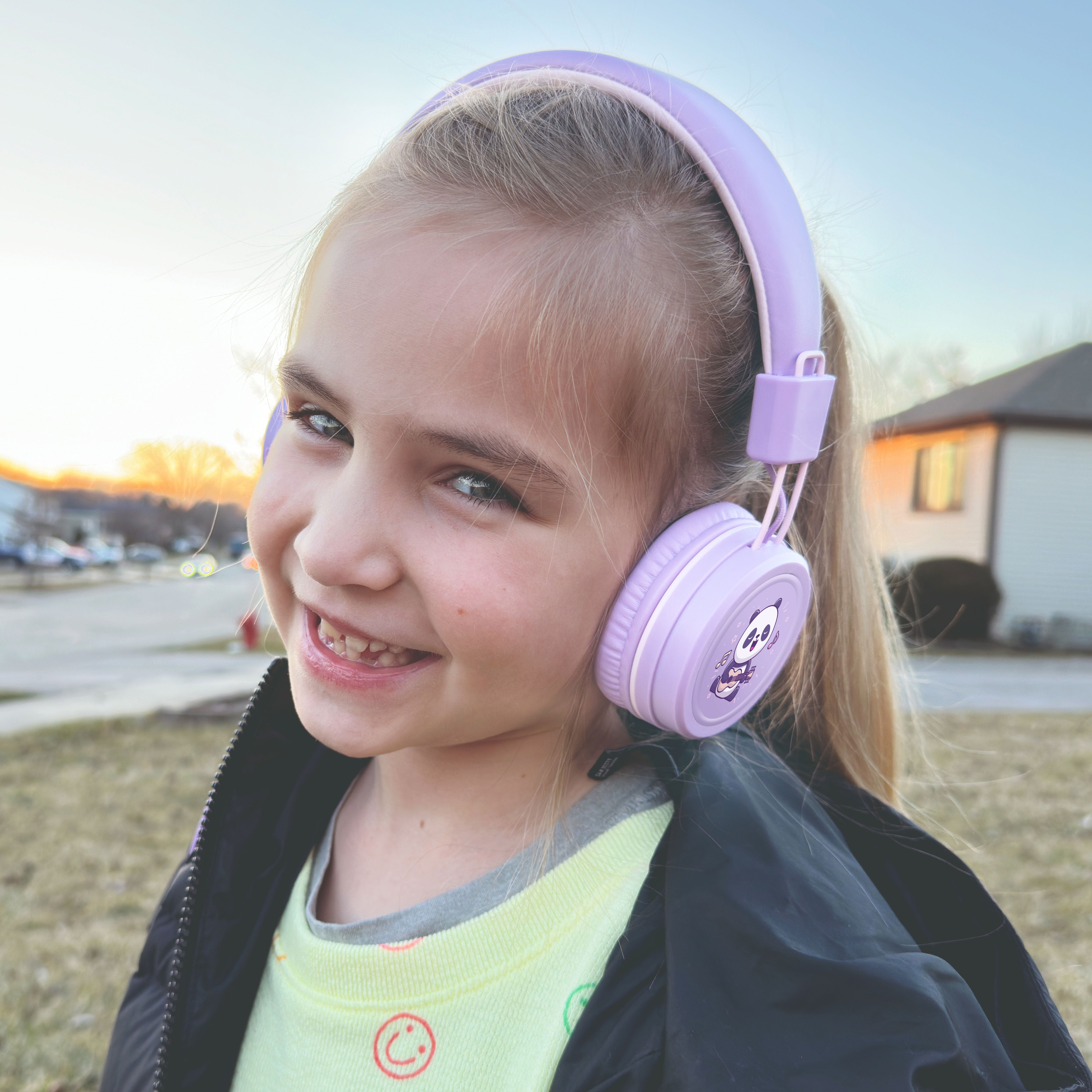Child wearing MEE audio KidJamz KJ55 Wired Children’s Headphones with 3.5mm Plug, Colorful Graphics, Volume Limiter & Microphone, Adjustable On-Ear Kids Headset for Online Learning/School/Travel/Tablet
