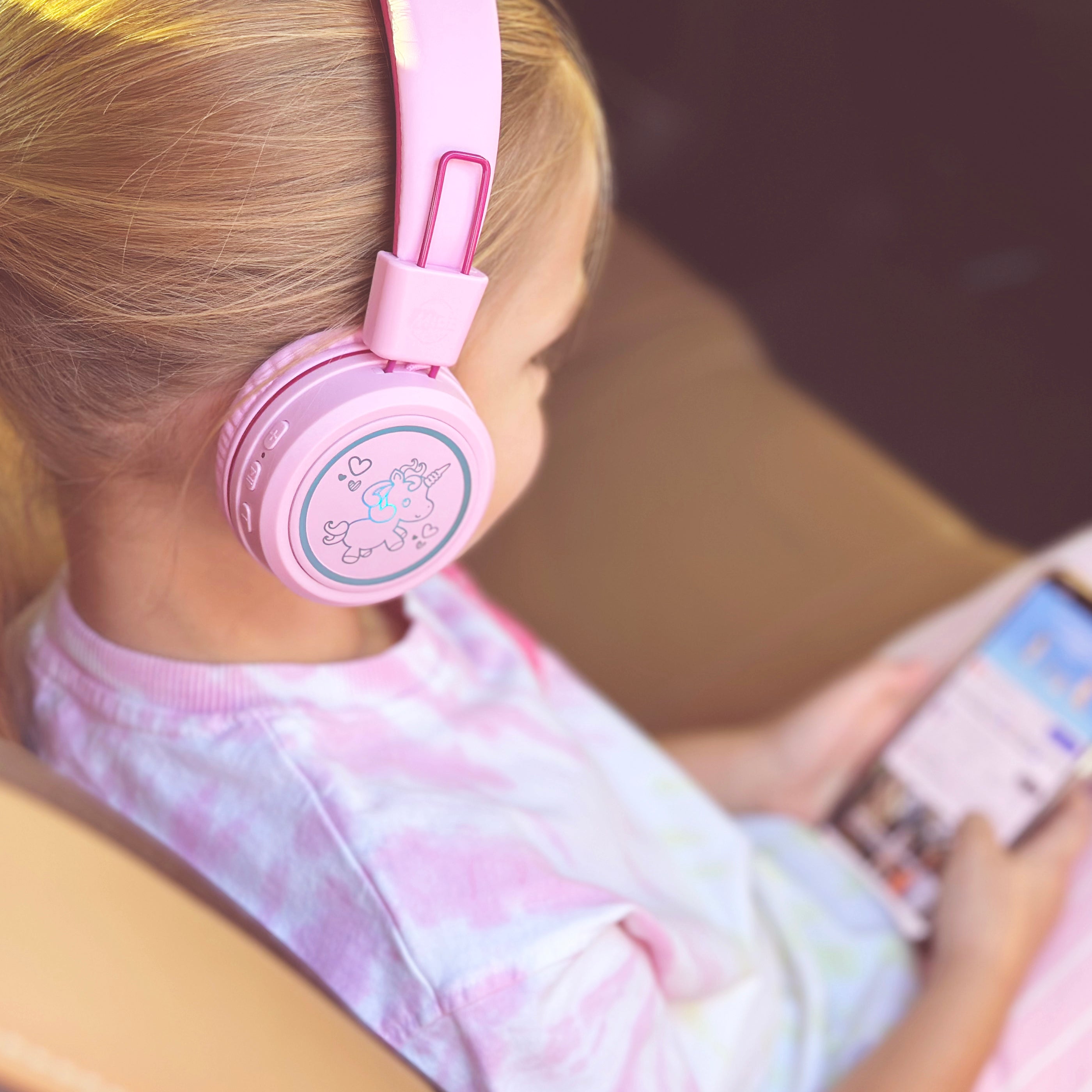 Image of a girl wearing the MEE audio KidJamz KJ55BT Bluetooth Wireless Safe Listening Headphones for Children with LED Lights, 85dB Volume Limiter, Microphone, & 40h battery; Kids Headset for School / iPhone / iPad / Tablet