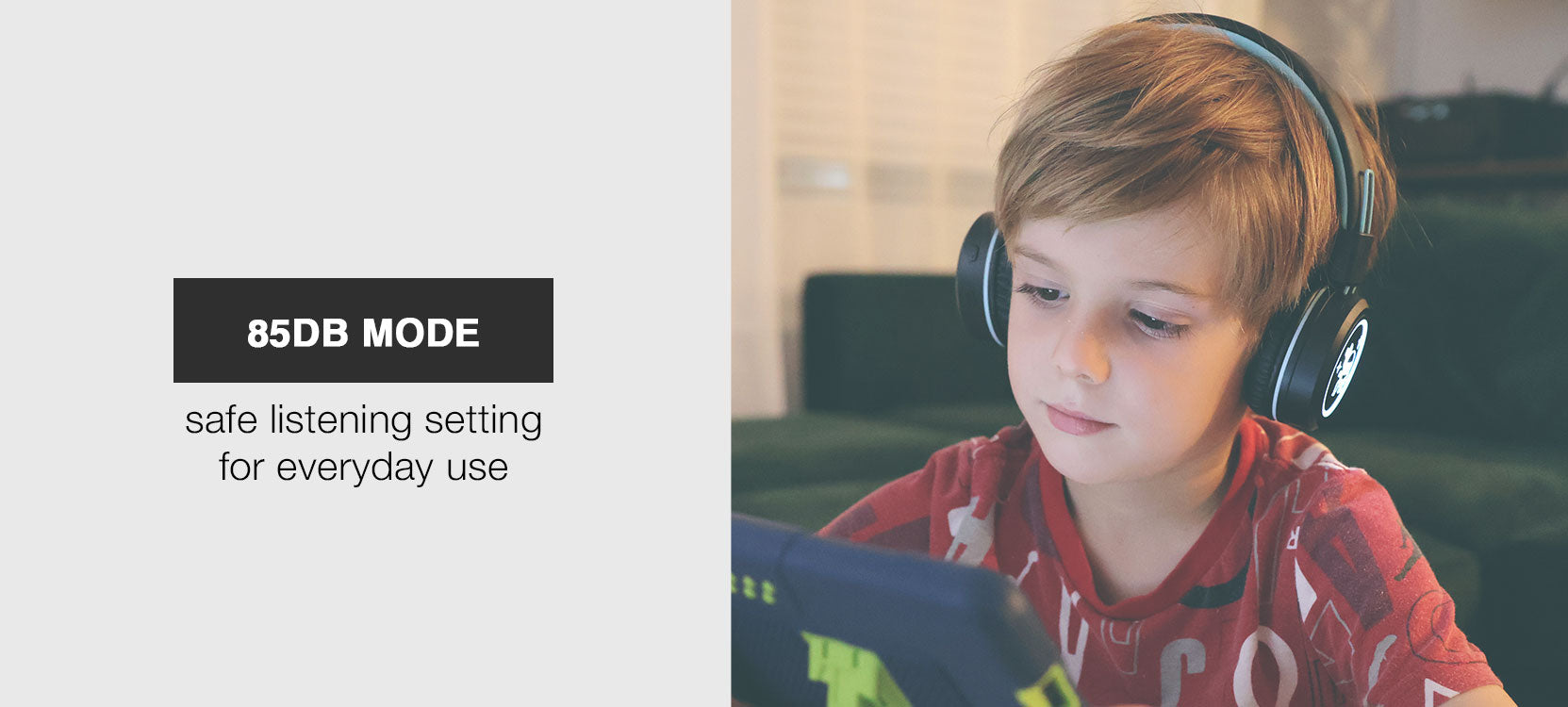 Image of a boy wearing the MEE audio KidJamz KJ55BT Bluetooth Wireless Safe Listening Headphones for Children with LED Lights, 85dB Volume Limiter, Microphone, & 40h battery; Kids Headset for School / iPhone / iPad / Tablet