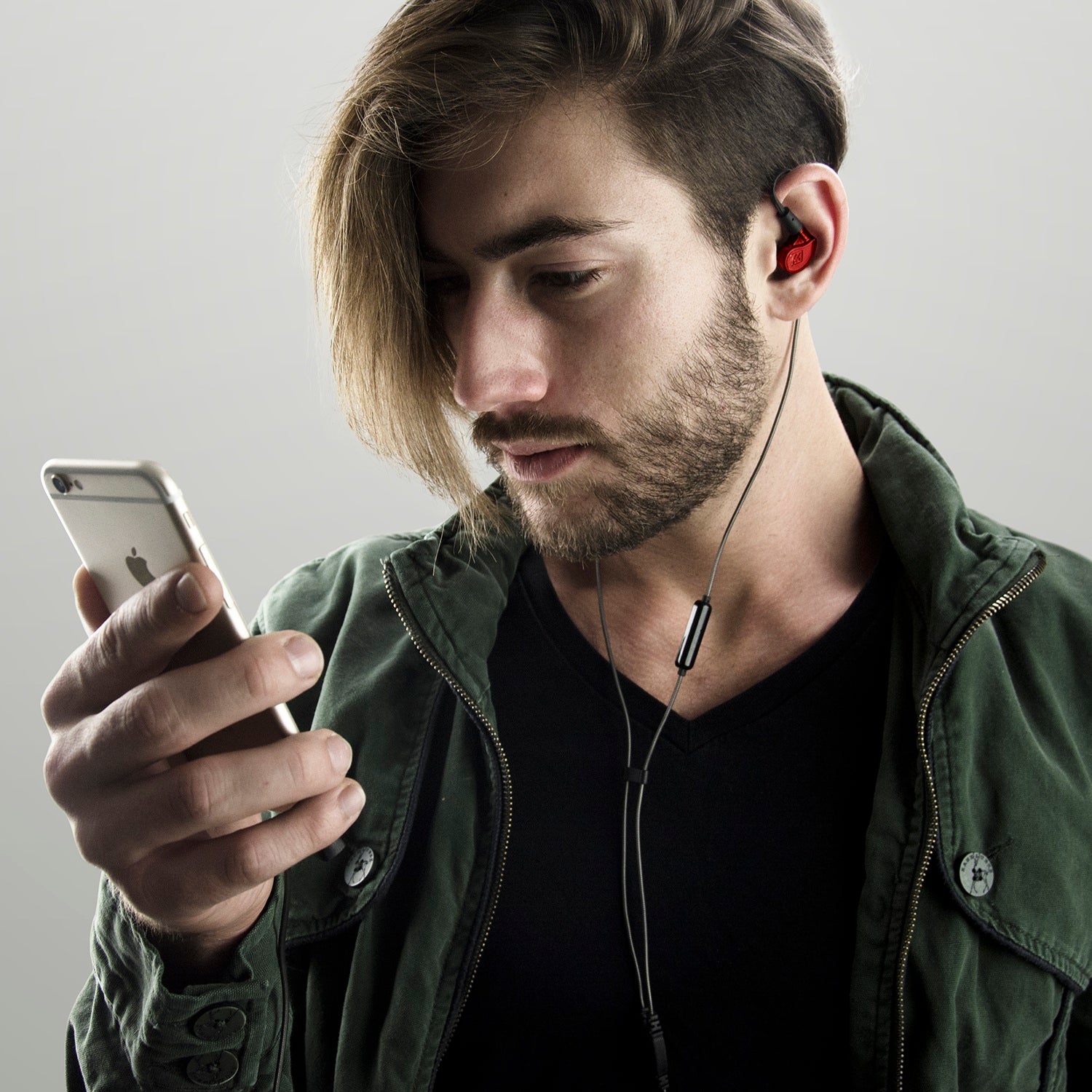musician wearing the mee audio m6pro in-ear monitors while on the phone