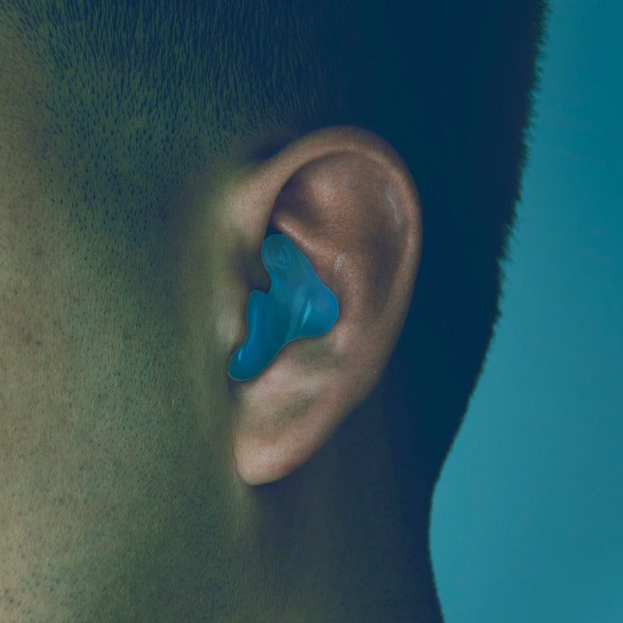 blue SNOO-Zs Earplugs shown in a human ear