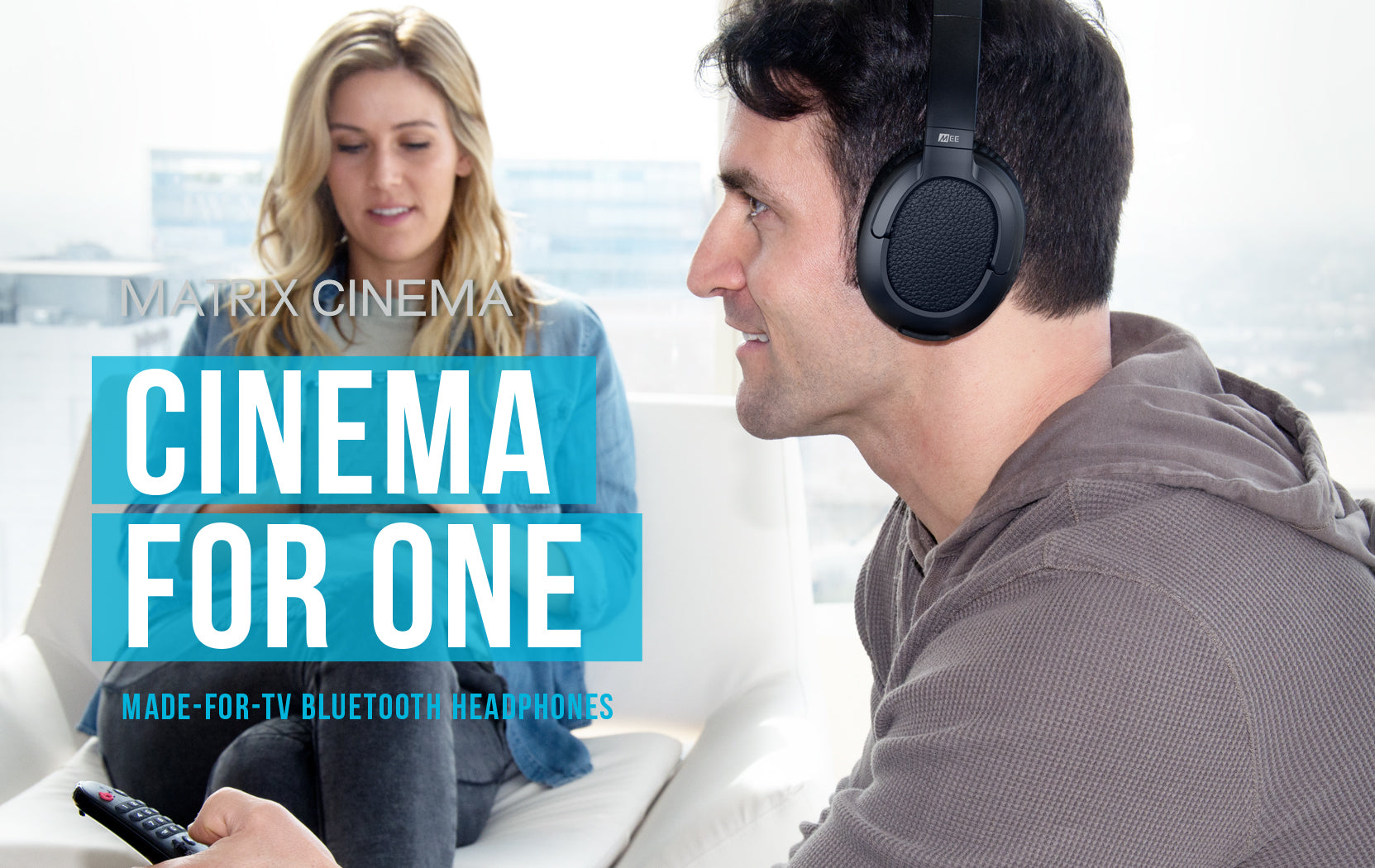 A man wearing headphones is using a remote control, sitting with a woman in the background. the text overlay reads "cinema for one - made-for-tv bluetooth headphones". bright, modern setting.