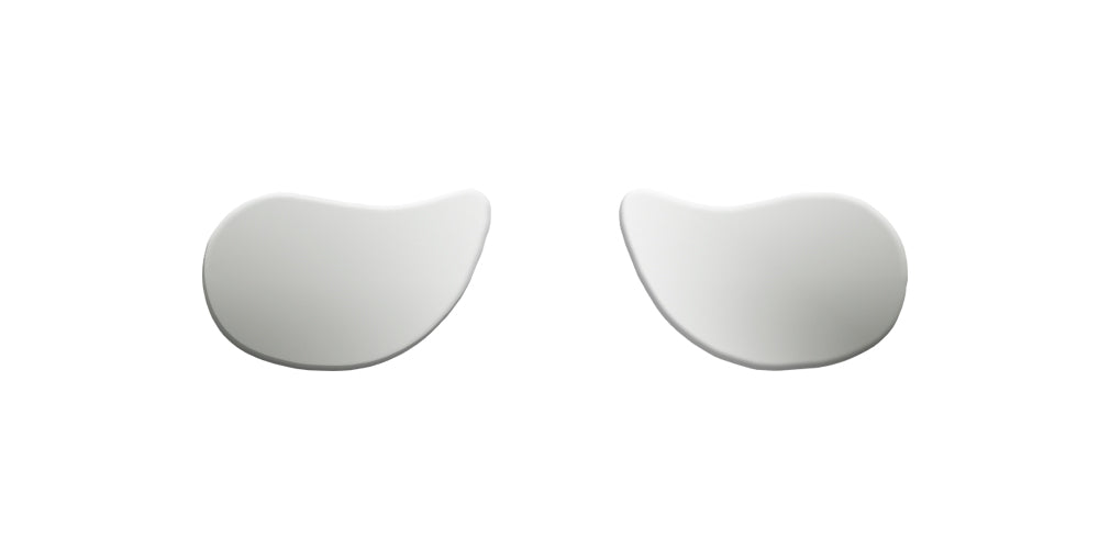 Two symmetrical white shapes resembling artful blobs or abstract designs, isolated on a plain white background.