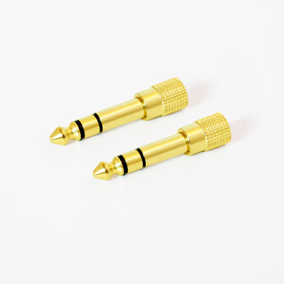 2 Gold-plated 1/4 inch Stereo audio adapters with a knurled grip on a white background