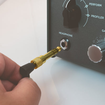 1/4 Adapter plugging into a headphone jack port