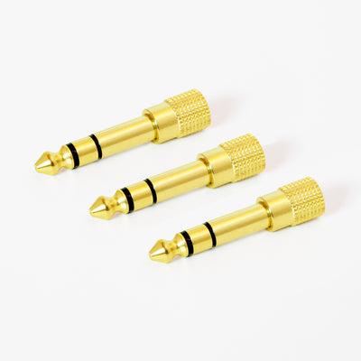 3 gold-plated 1/4 inch Stereo audio adapters with a knurled grip on a white background