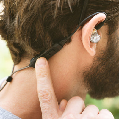 Man wearing BT3 Bluetooth Wireless Adapter Cable for In-Ear Monitors