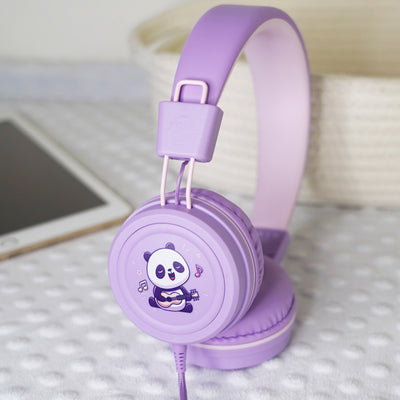 Lavender KidJamz KJ55AUX headphones with a cartoon Panda design holding a guitar while in color next to a tablet.