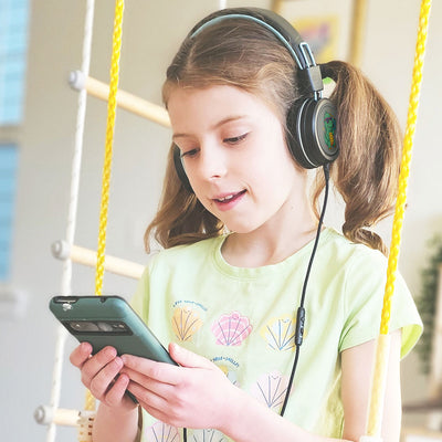 Child wearing MEE audio KidJamz KJ55 Wired Children’s Headphones with 3.5mm Plug, Colorful Graphics, Volume Limiter & Microphone, Adjustable On-Ear Kids Headset for Online Learning/School/Travel/Tablet