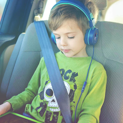 Child wearing MEE audio KidJamz KJ55 Wired Children’s Headphones with 3.5mm Plug, Colorful Graphics, Volume Limiter & Microphone, Adjustable On-Ear Kids Headset for Online Learning/School/Travel/Tablet