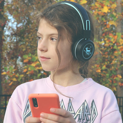 Image of a girl wearing the MEE audio KidJamz KJ55BT Bluetooth Wireless Safe Listening Headphones for Children with LED Lights, 85dB Volume Limiter, Microphone, & 40h battery; Kids Headset for School / iPhone / iPad / Tablet