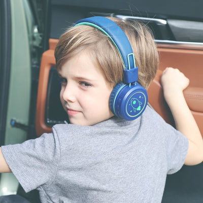 Image of a boy wearing MEE audio KidJamz KJ55BT Bluetooth Wireless Safe Listening Headphones for Children with LED Lights, 85dB Volume Limiter, Microphone, & 40h battery; Kids Headset for School / iPhone / iPad / Tablet