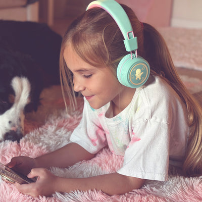 Image of a girl wearing the MEE audio KidJamz KJ55BT Bluetooth Wireless Safe Listening Headphones for Children with LED Lights, 85dB Volume Limiter, Microphone, & 40h battery; Kids Headset for School / iPhone / iPad / Tablet