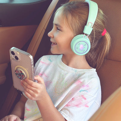 Image of a girl wearing the MEE audio KidJamz KJ55BT Bluetooth Wireless Safe Listening Headphones for Children with LED Lights, 85dB Volume Limiter, Microphone, & 40h battery; Kids Headset for School / iPhone / iPad / Tablet