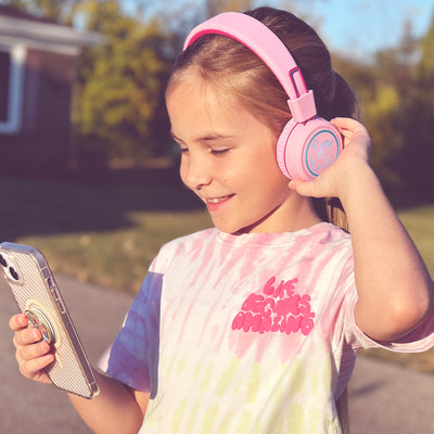 Image of a girl wearing the MEE audio KidJamz KJ55BT Bluetooth Wireless Safe Listening Headphones for Children with LED Lights, 85dB Volume Limiter, Microphone, & 40h battery; Kids Headset for School / iPhone / iPad / Tablet