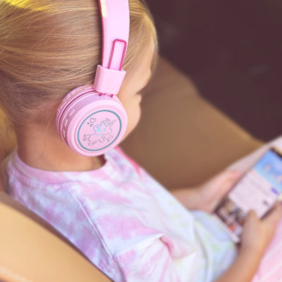 Image of a girl wearing the MEE audio KidJamz KJ55BT Bluetooth Wireless Safe Listening Headphones for Children with LED Lights, 85dB Volume Limiter, Microphone, & 40h battery; Kids Headset for School / iPhone / iPad / Tablet