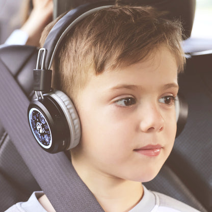 a child wearing the MEE audio KidJamz Share Bluetooth Headphones inside a car