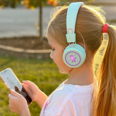 Image of a girl wearing the MEE audio KidJamz KJ55BT Bluetooth Wireless Safe Listening Headphones for Children with LED Lights, 85dB Volume Limiter, Microphone, & 40h battery; Kids Headset for School / iPhone / iPad / Tablet