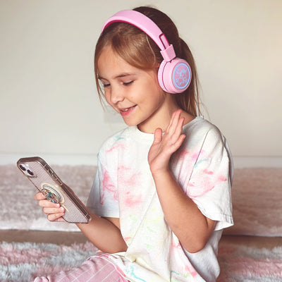 Image of a girl wearing the MEE audio KidJamz KJ55BT Bluetooth Wireless Safe Listening Headphones for Children with LED Lights, 85dB Volume Limiter, Microphone, & 40h battery; Kids Headset for School / iPhone / iPad / Tablet