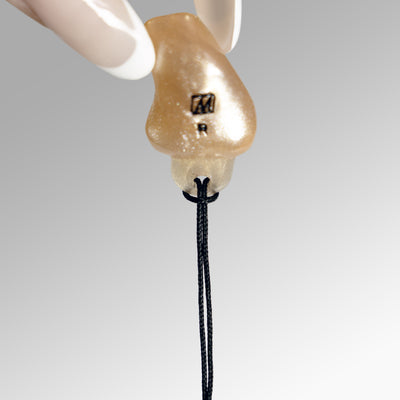 A black lanyard connected to a gold earplug