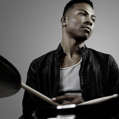 Drummer wearing black M6 PRO in-ear monitors