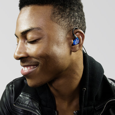 Man wearing blue M6 PRO in-ear monitors