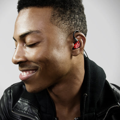 Man wearing red M6PRO in-ear monitors