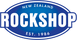 Logo of new zealand rockshop, featuring a blue oval with white and green borders, and the text "new zealand rockshop est. 1986" in white on a green background.