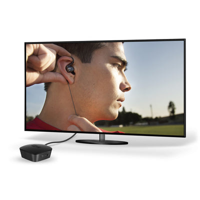 Image of Connect Bluetooth Audio Transmitter plugged into a TV showing a man wearing MEE Audio earphones. 